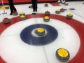 Uplawmoor Curling Club curling stones in ice head